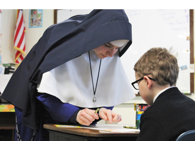 Sister teaching in the first grade classroom