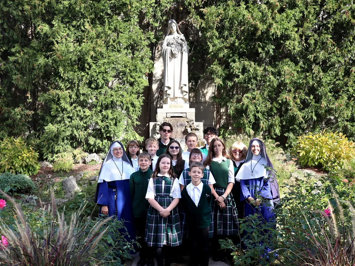 Students and teachers from St. Joseph’s of Wayne, Michigan, venerated the relics of St. Therese on her feastday when the reliquary was brought on tour to the U.S. This photo is taken on the grounds of the National Shrine of the Little Flower in Royal Oak, Michigan.