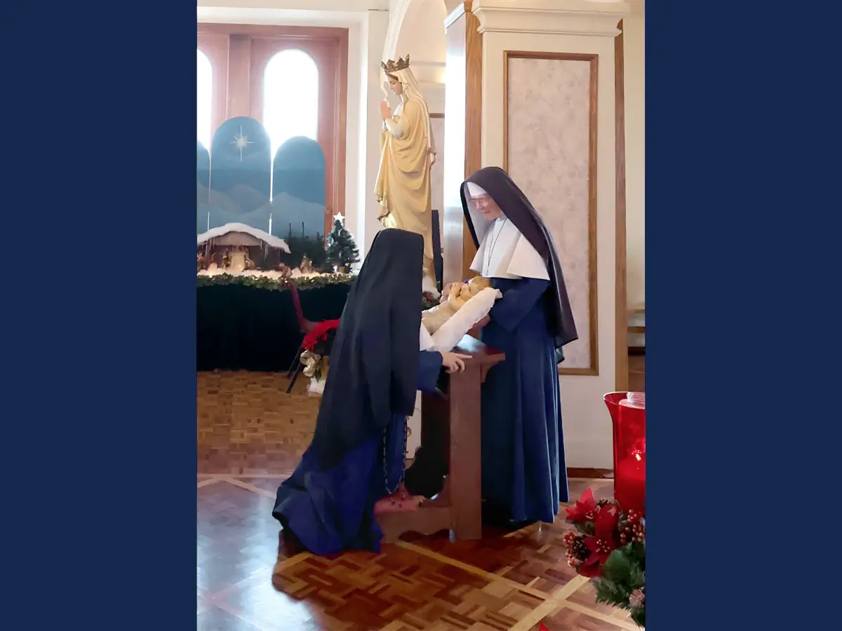 From youngest to oldest each Sister approaches to kiss the feet of the Infant Jesus while special devotions are read.