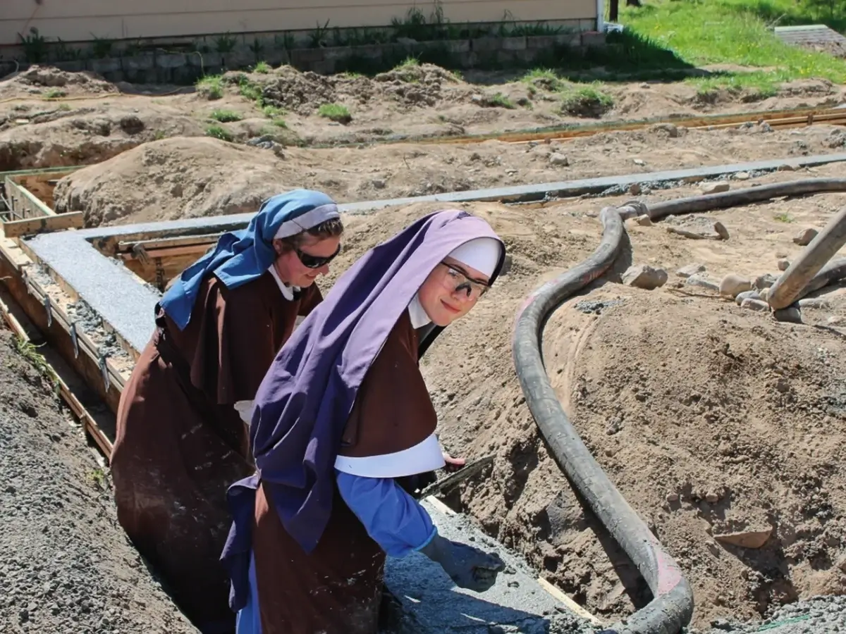 Postulants and novices help where they can on preparing for the foundation of the new novitiate chapel.