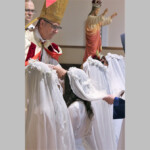 The postulants, arrayed in white dresses, have their hair cut to signify that they are giving themselves wholly to God.