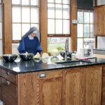 Sr. Mary Antoinette works in our newly-renovated convent kitchen to processes cabbage into sauerkraut for the winter.