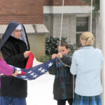 Sr. Bernardine Marie’s 4th grade class raises the flag every morning at Mount St. Michael, but raising it for the Veterans’ Day observance was an even greater privilege.