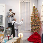 Fr. Casimir Puskorius blesses the Sisters’ Christmas tree. On February 2nd, one of the Sisters experimentally replanted it, hoping for its reuse next Christmas. Blessing of the Christmas tree in the convent refectory.