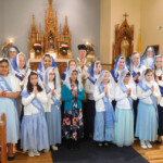 Sr. Mary Imelda and Sr. Mary Genevieve pose with members of Salve Regina Sodality and Children of Mary after advancement ceremonies on December 8 at the City of Mary, Rathdrum, Idaho. Advancement ceremonies for the Salve Regina Sodality and Children of Mary took place on December 8 at the City of Mary, Rathdrum, Idaho.