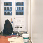 Sr. Maria Dolorosa primes the doors to the entrance hallway of the parish hall of St. Theresa’s Church in Maine. Painting the entrance to the parish hall.