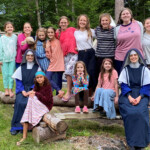 Sr. Mary Teresita and Sr. Mary Evangeline pose with the campers of Camp St. Theresa, held in New England. It was the first annual camp, filled with fun, games and catechism, of course.