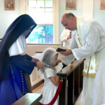 Sr. Maria Ines assists as a First Communicant is enrolled in the Brown Scapular.