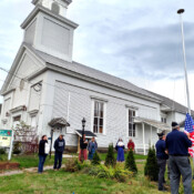 Proud to be an American! The local American Legion erects a flagpole for St. Theresa’s Church (Oakland, Maine), performing a military ceremony as they hang the flag for the first time. Veterans raise the flag after erecting a new flagpole at St. Theresa's Church