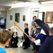 Andale, Nino!! Sr. Maria Dolorosa gets a young pinata enthusiast pointed in the right direction during the All Saints’ Day party (Middleville, Michigan).