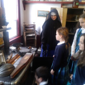 Sr. Mary Teresita and students of St. Theresa School (Oakland, Maine) look at artifacts displayed in the Redington Museum in Waterville, Maine, a two-story house dating back to 1814.