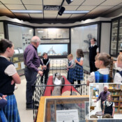 Students from Holy Guardian Angels School (Olathe, Colorado) are intrigued by dinosaur bones at the Delta County Historical Society Museum.