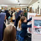 Sr. Maria Regina admires the Academic Fair displays at St. Mary’s in Tacoma. The students presented a variety of history-themed reports.