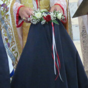 Sr. Dymphna Marie receives the blue veil and crown of roses as she makes her first profession of vows.