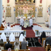 While the Litany of the Saints is chanted, the two new perpetually-professed Sisters, Sr. Mariana and Sr. Maria Goretti, lie under a funeral pall, signifying they are now dead to the world.