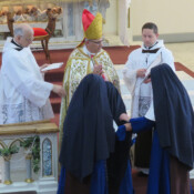 Temporary profession of vows for three years precedes the taking of final vows. The large brown scapular is received at this step by Sr. Mary Fatima.