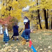Sr. Maria Dolorosa and her students help tidy up the grounds at Holy Rosary Church in Middleville, Michigan.