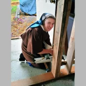Sr. Virginia gets some construction experience as a section of the barn is closed in for a storage area.