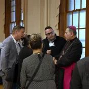 Bishop Martin Davila visits with guests after speaking on his work among the faithful in Mexico.