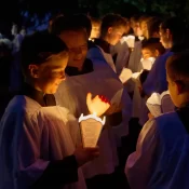 Knights of the Altar get their candles ready for the Candlelight procession.