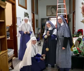 Christmas decorating is a group effort in a building the size of Mount St. Michael.