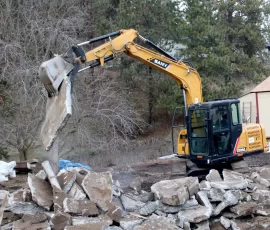 Brother Thomas demolishes the old faulty foundation to prepare for the new building which will house the novitiate chapel.
