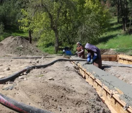 New life skills for novices and postulants: spreading concrete for the footings at the novitiate project site.