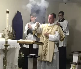 Fr. Stephen Sandquist chants the Exultet during the Easter Vigil ceremonies at Our Lady of Fatima Church in Chelsea, Oklahoma.