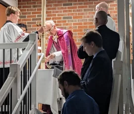 Fr. Gregory Drahman, CMRI, blesses the Paschal candle during the Easter Vigil at Sacred Heart Church in Akron, Ohio.